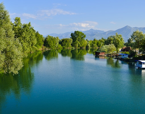Moraca river delta with boats and greenery at Skadar Lake, Montenegro.