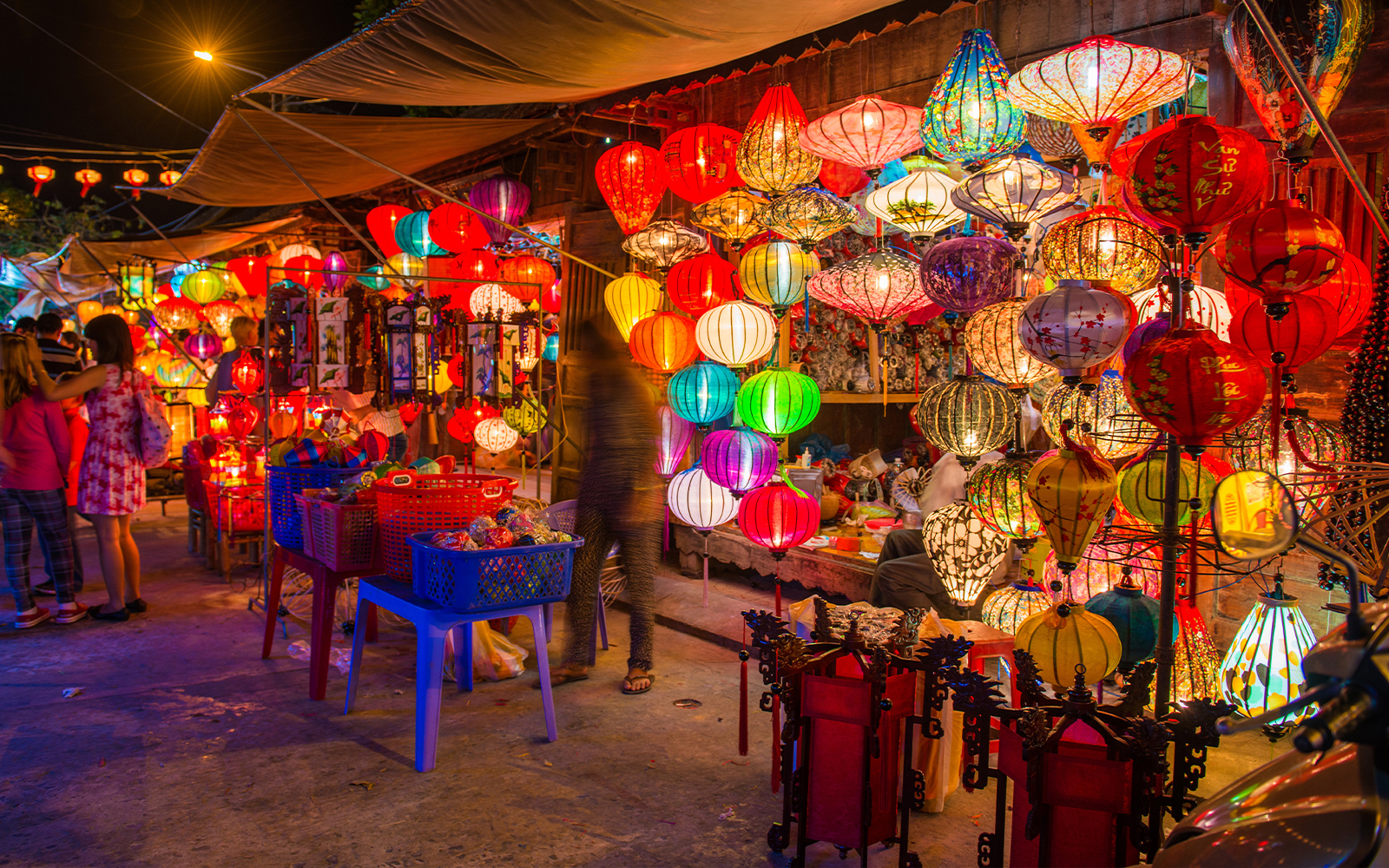 Colorful lanterns illuminating a night market in Hoi An ancient town.