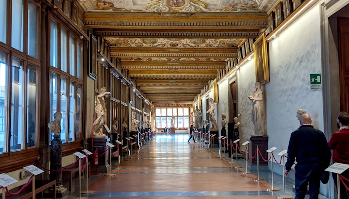Accademia Gallery entrance with visitors, Florence Wonders Tour, Renaissance art focus.