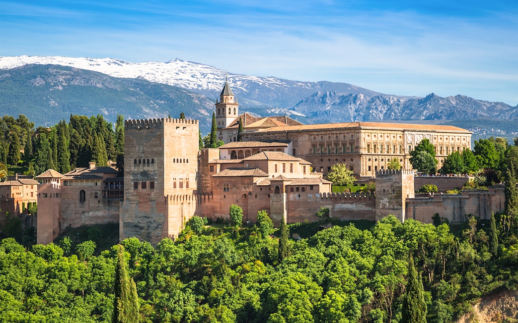 Alhambra palace complex with Sierra Nevada mountains in Granada, Spain.