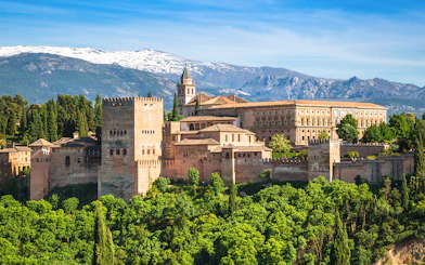 Alhambra palace complex with Sierra Nevada mountains in Granada, Spain.