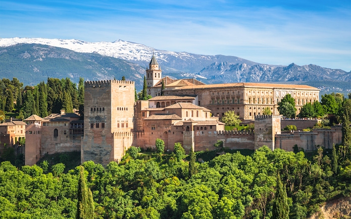 Alhambra palace complex with Sierra Nevada mountains in Granada, Spain.