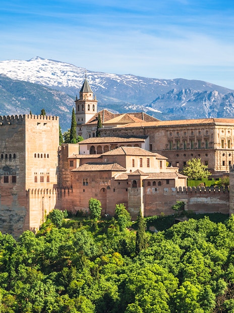 Alhambra palace complex with Sierra Nevada mountains in Granada, Spain.