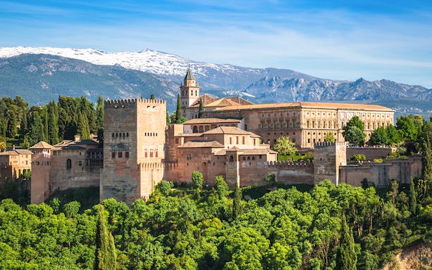Alhambra palace complex with Sierra Nevada mountains in Granada, Spain.