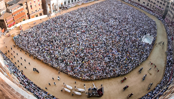Crowd gathered at Siena’s Palio horse race in Piazza del Campo, Italy.