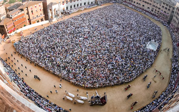 Crowd gathered at Siena’s Palio horse race in Piazza del Campo, Italy.