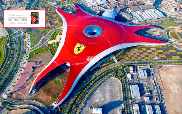 Aerial view of Ferrari World Abu Dhabi's iconic red roof structure.
