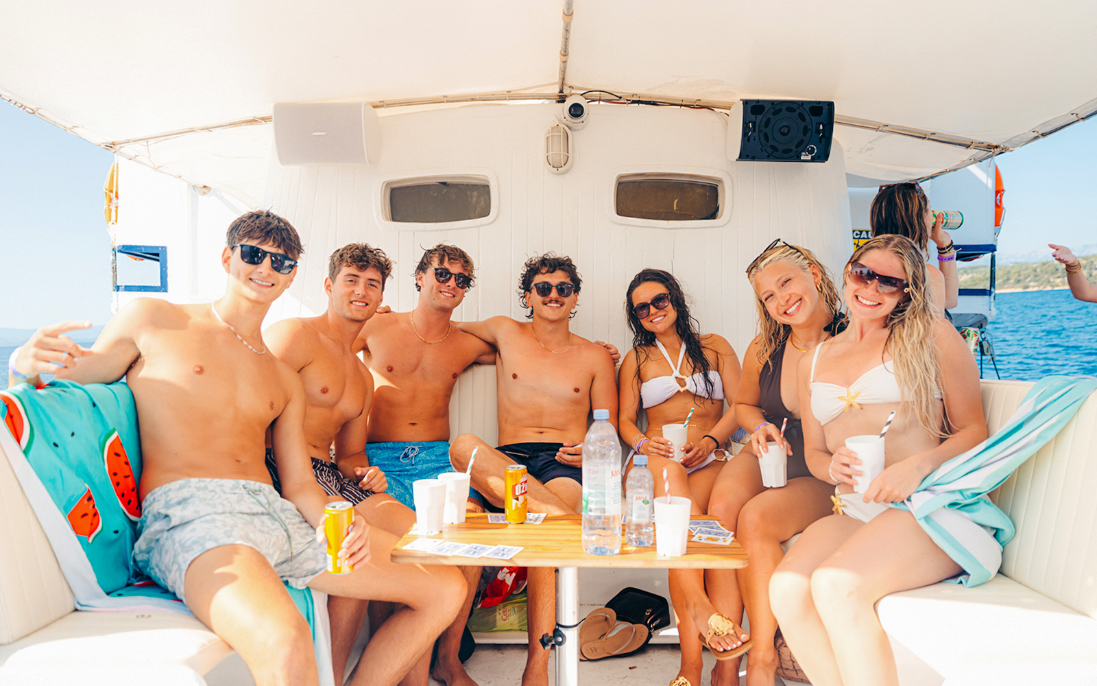 Guests relaxing on a boat during a sunset party in Split, Croatia.