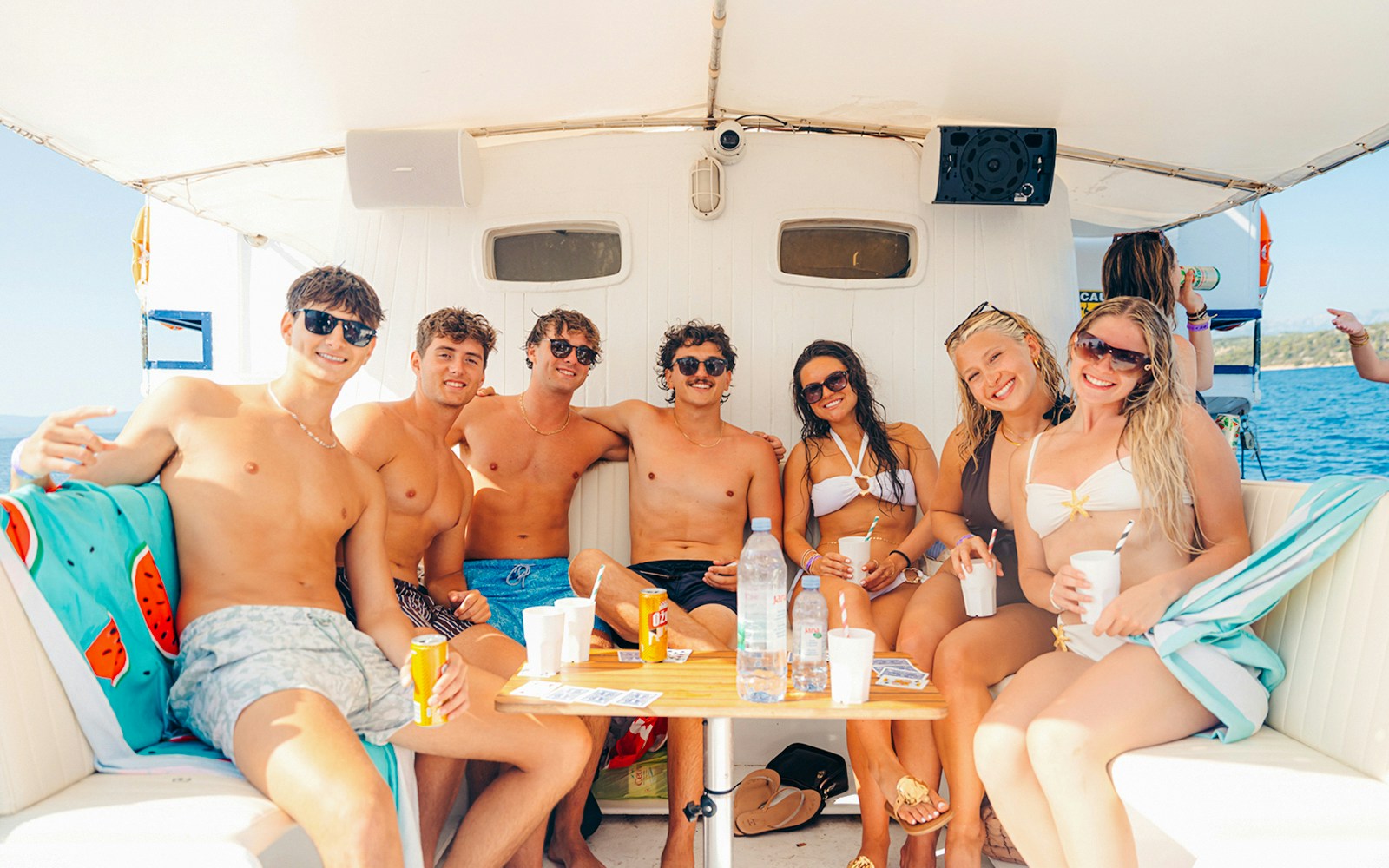 Guests relaxing on a boat during a sunset party in Split, Croatia.