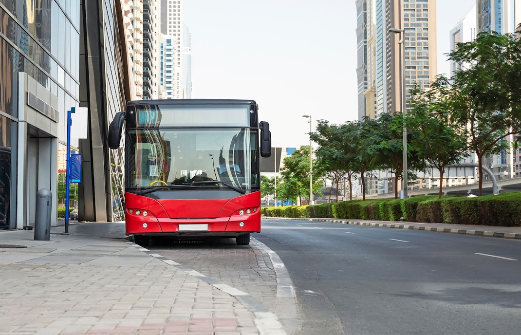 Tourist bus on the street of Dubai, United Arab Emirates.