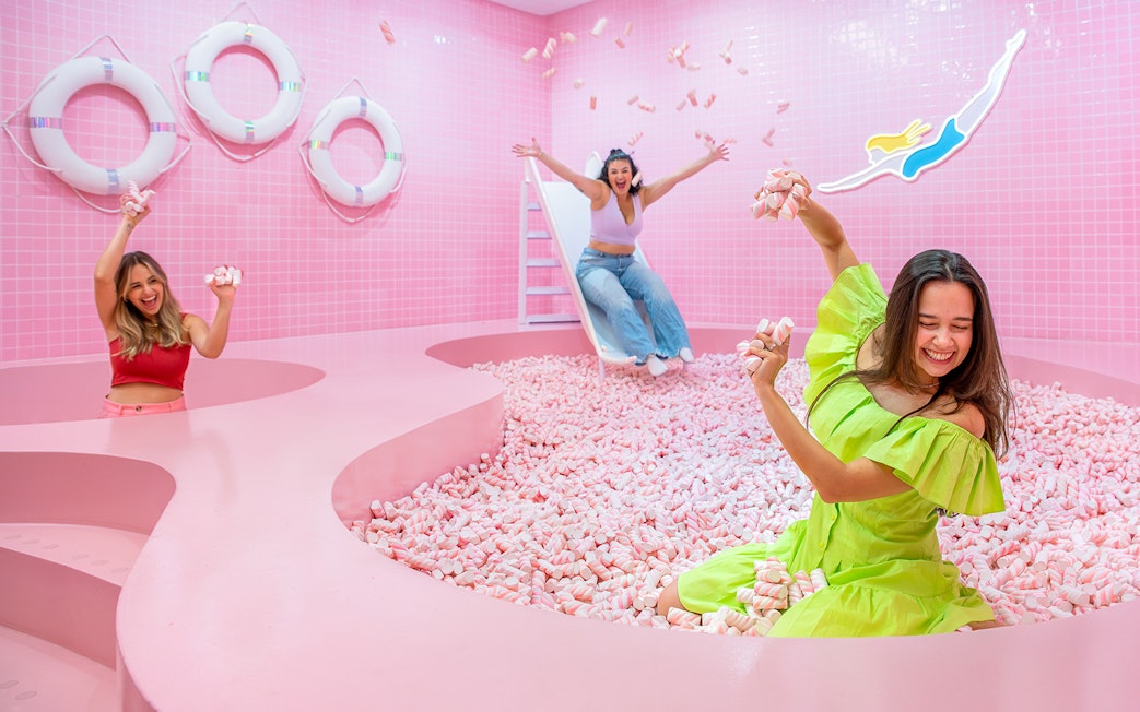 Visitors enjoying a pink marshmallow pool at a Liverpool attraction.