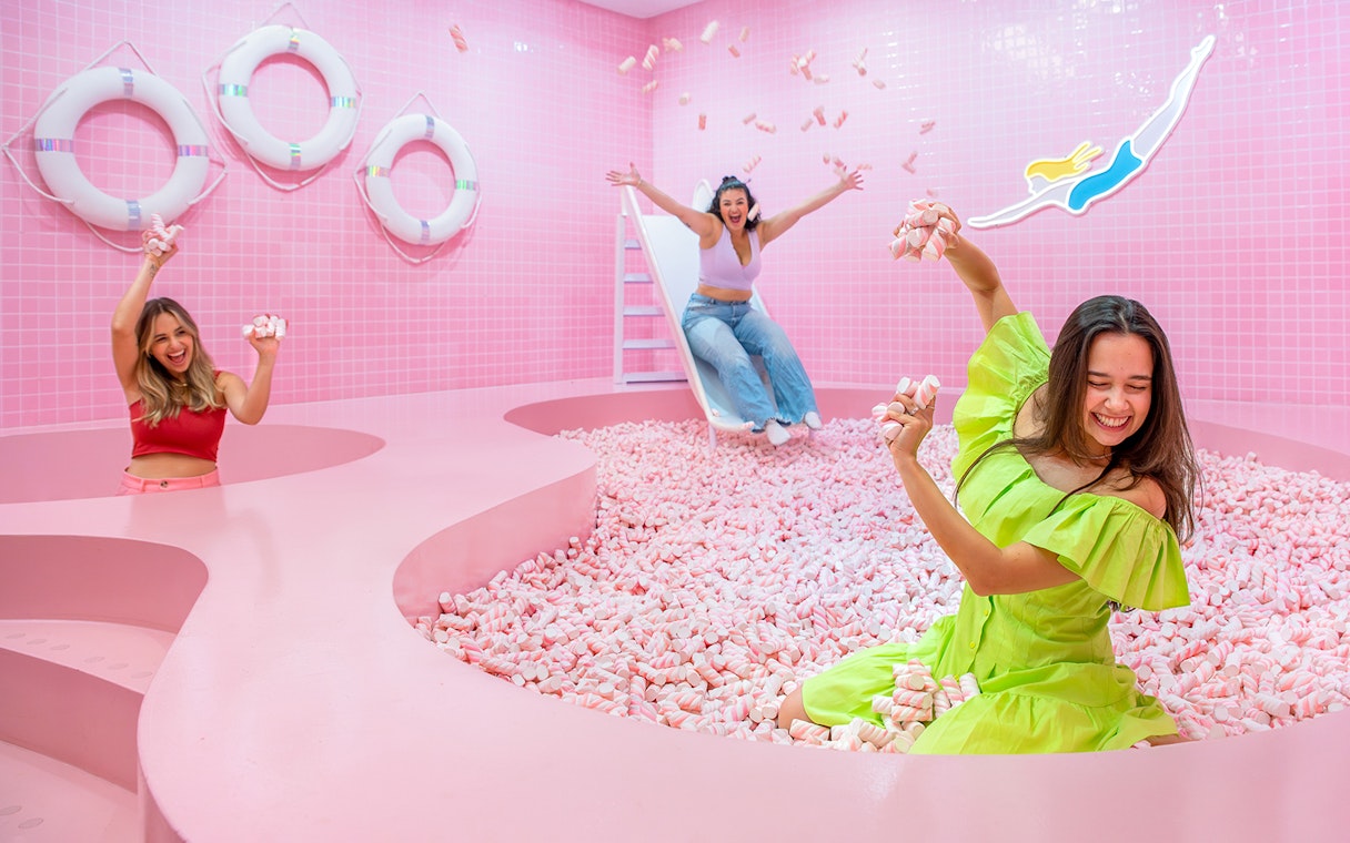 Visitors enjoying a pink marshmallow pool at a Liverpool attraction.