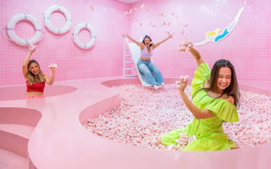 Visitors enjoying a pink marshmallow pool at a Liverpool attraction.