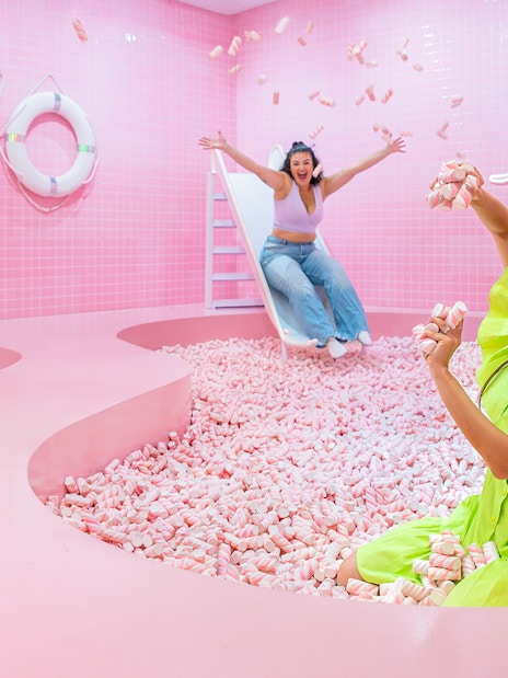 Visitors enjoying a pink marshmallow pool at a Liverpool attraction.