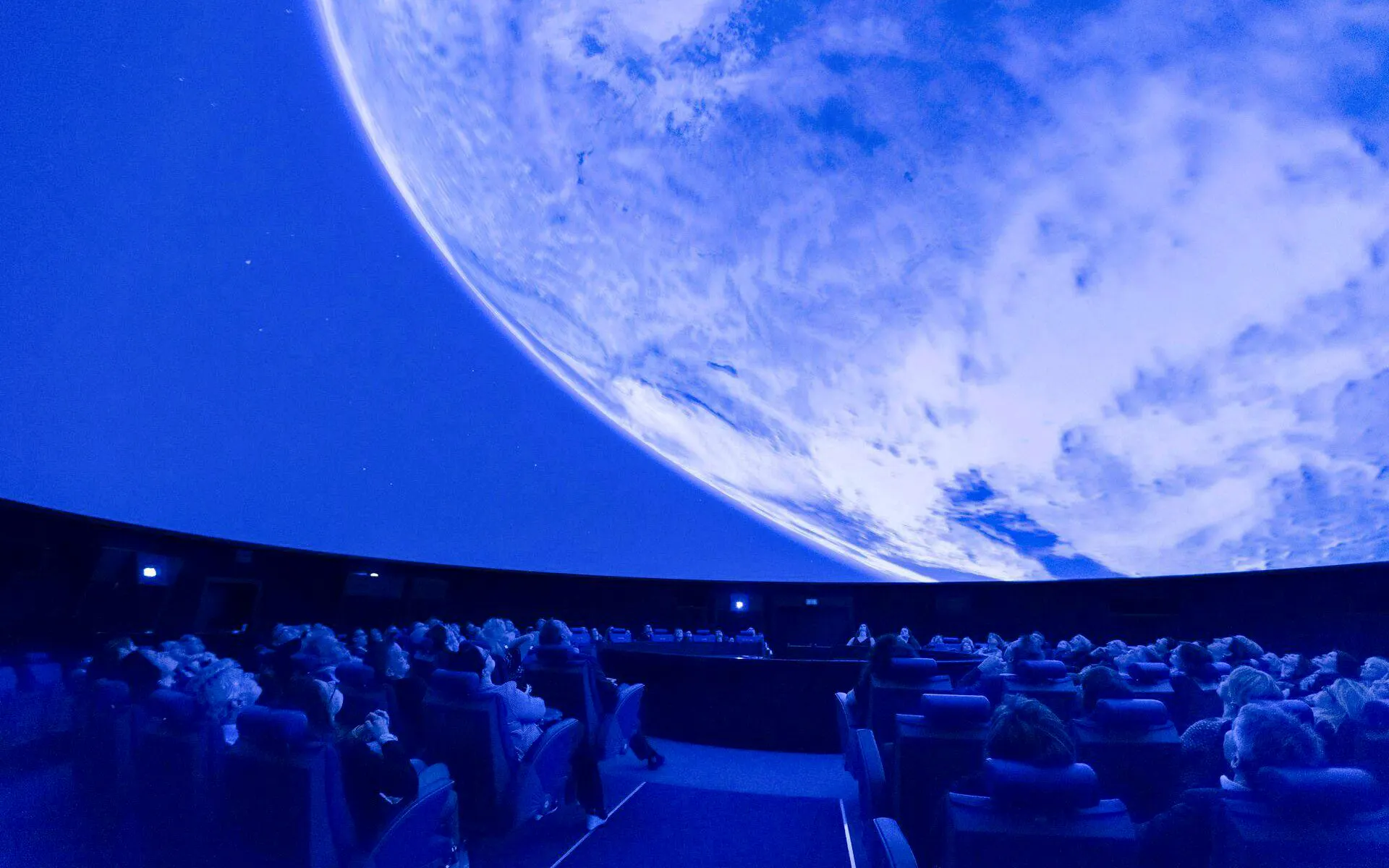 Guests watching a planetarium show at the Museum of Transport in Lucerne.