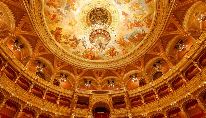Guests and tour guide inside the ornate Hungarian State Opera House.