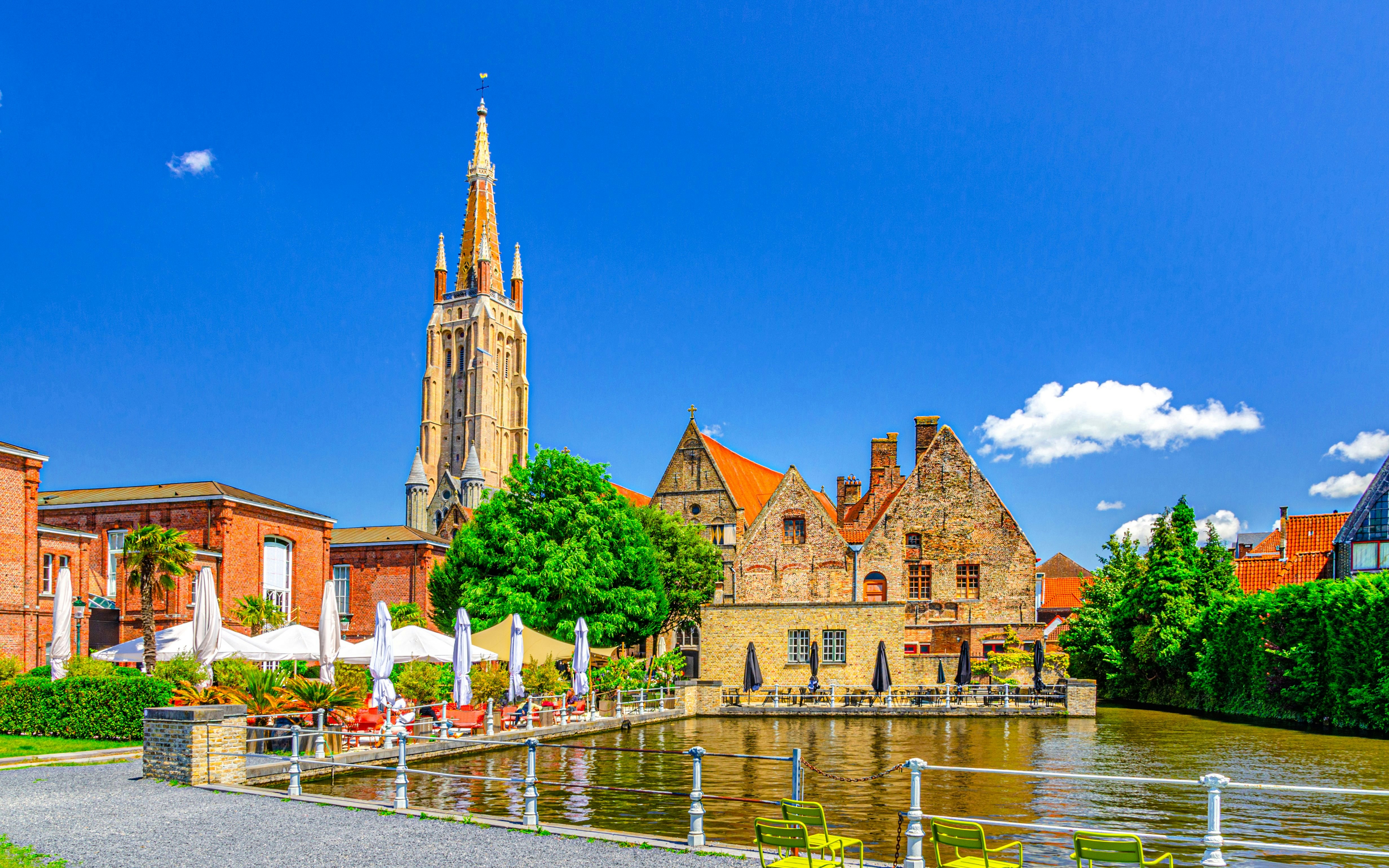 Bakkersrei canal with Church of Our Lady and Old St John’s Hospital in Brugge old town.