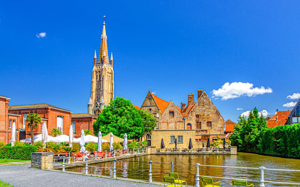 Bakkersrei canal with Church of Our Lady and Old St John’s Hospital in Brugge old town.