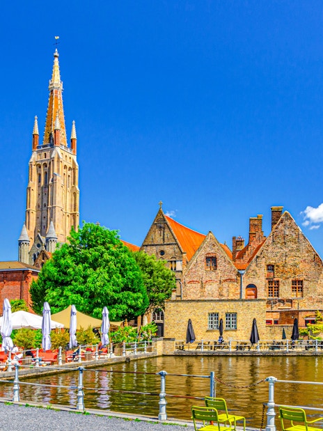 Bakkersrei canal with Church of Our Lady and Old St John’s Hospital in Brugge old town.