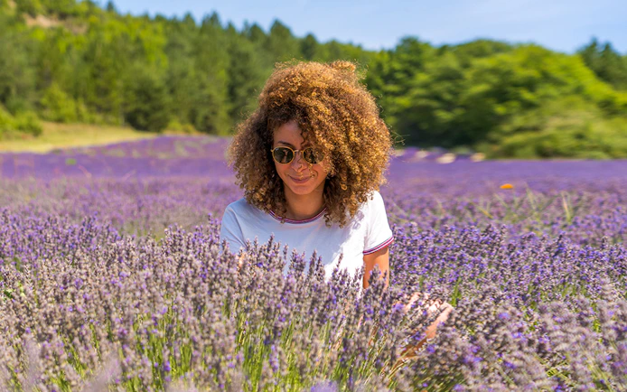 Woman enjoying lavender field in Sault, France.