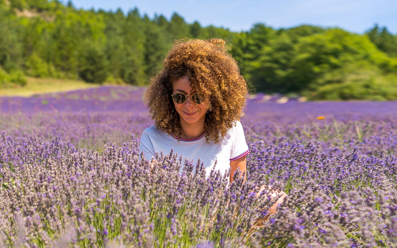 Woman enjoying lavender field in Sault, France.