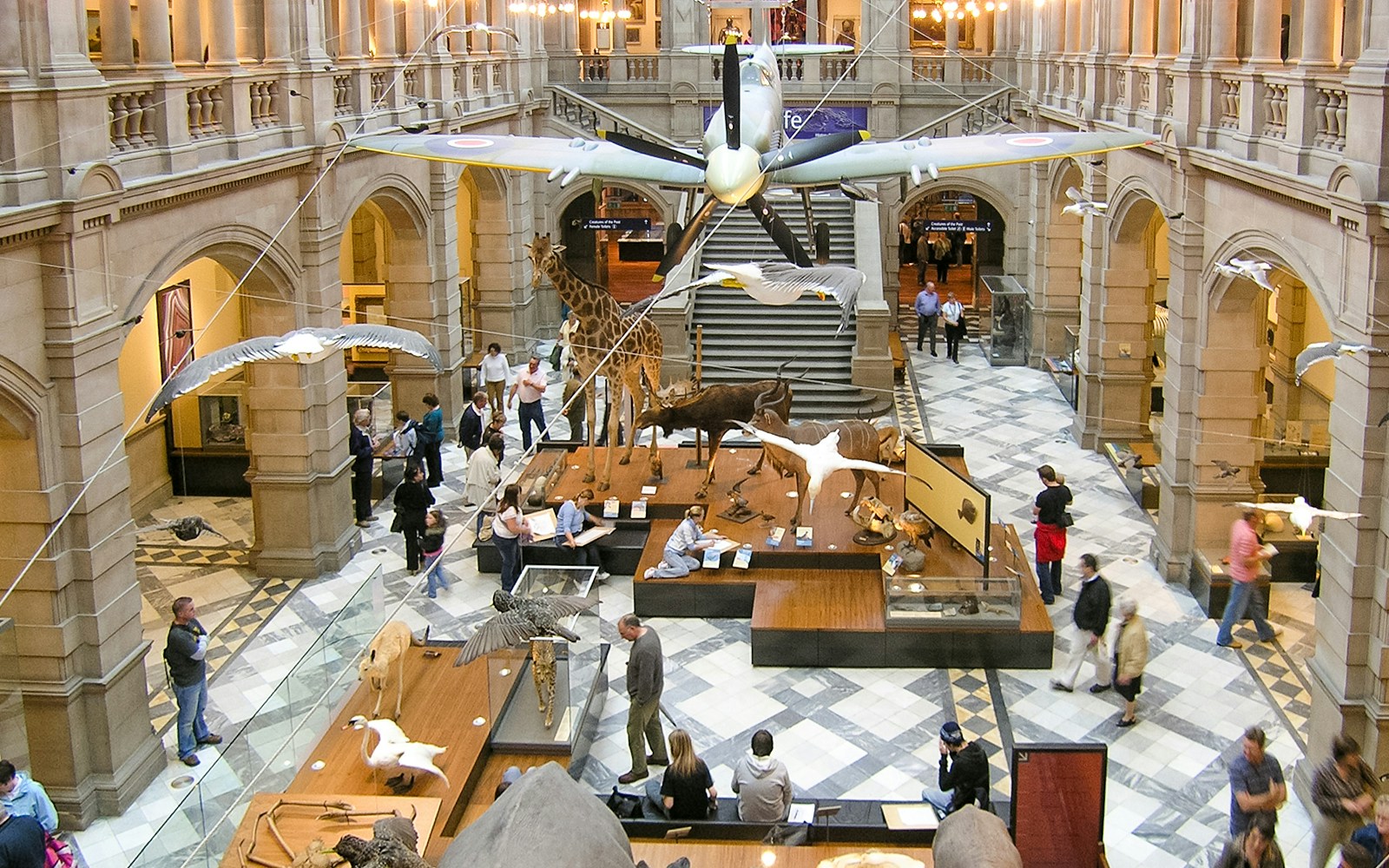 Visitors and artworks inside the Kelvingrove Art Gallery and Museum