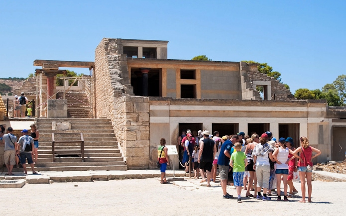 Visitors exploring the ruins of Knossos Palace in Crete.