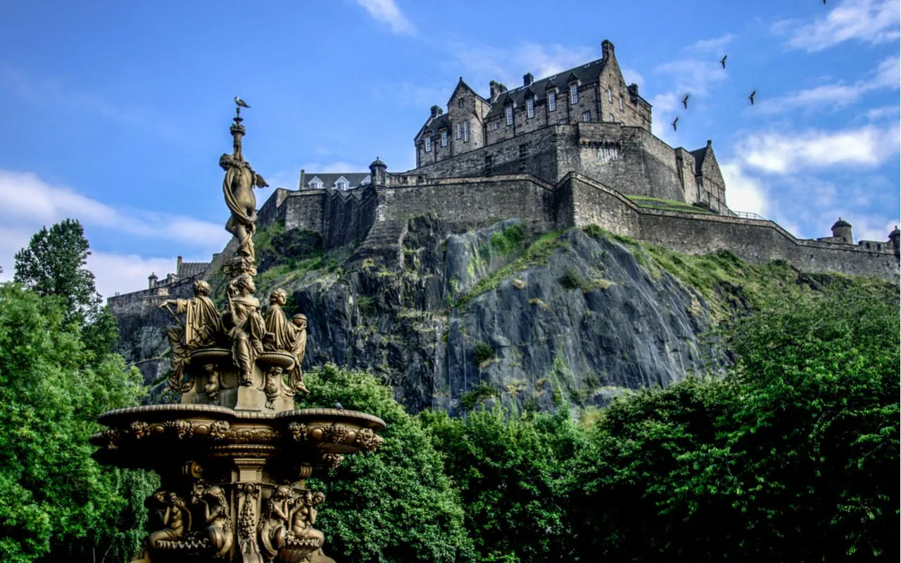 Edinburgh Castle atop Castle Rock with Ross Fountain in the foreground.