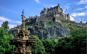 Edinburgh Castle atop Castle Rock with Ross Fountain in the foreground.