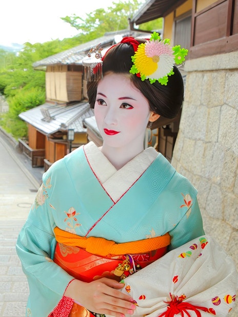 Maiko in traditional kimono on a historic street in Kyoto during a makeover photoshoot.