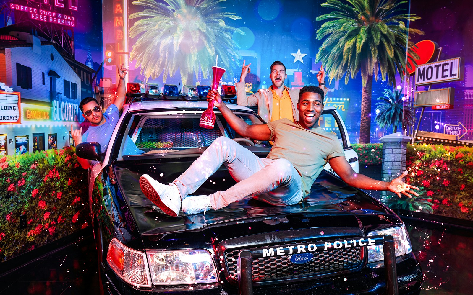 Guests posing with a police car at Madame Tussauds Las Vegas.