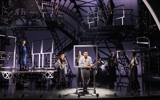 Theatrical performance with actors on an industrial set, related to Lempicka.
