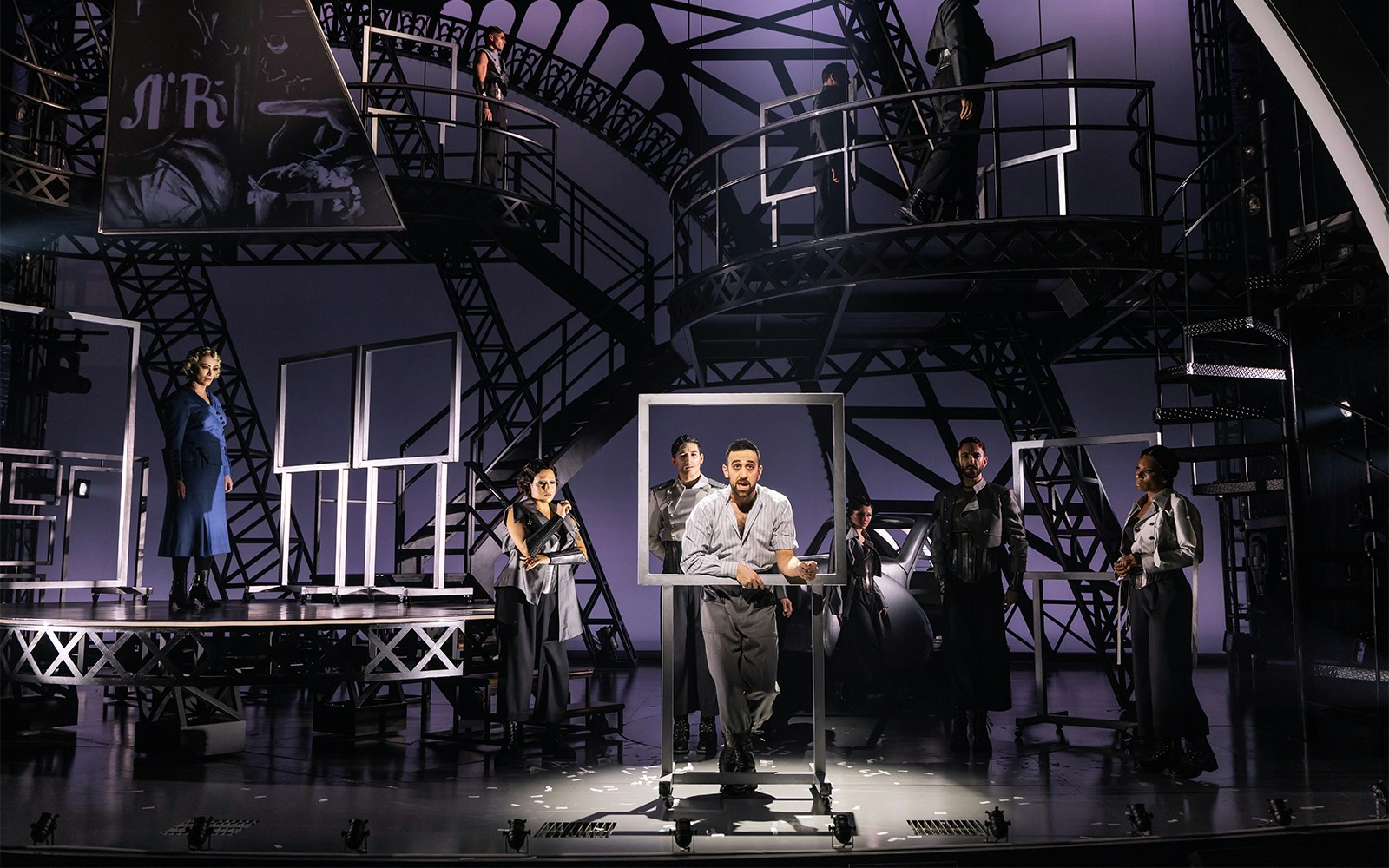 Theatrical performance with actors on an industrial set, related to Lempicka.