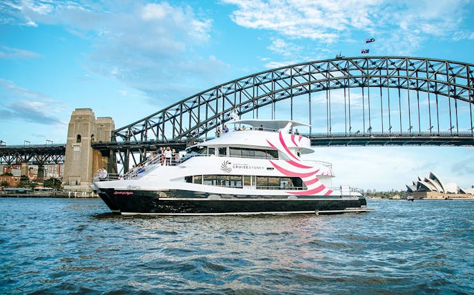 Spirit of Migloo sailing on Sydney Harbour with Sydney Harbour Bridge in the background.