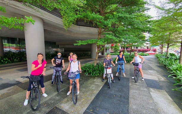 Group of cyclists on a guided historical bike tour in Singapore.