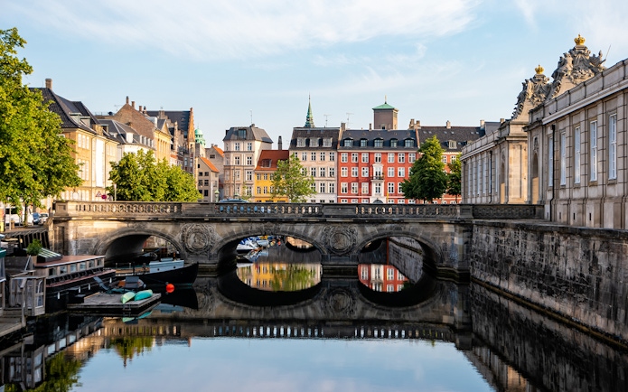 Marmorbroen bridge over canal with colorful buildings in Copenhagen, Denmark.