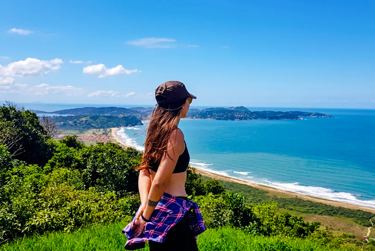 Woman admiring ocean view from Telegraph Stone Trail, Rio de Janeiro.