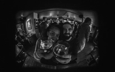 Couple enjoying drinks at a lively bar during Reykjavík private bar crawl.