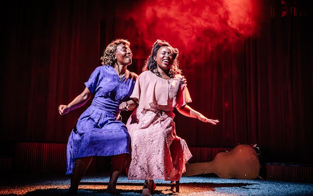 Two performers sing passionately on stage in a scene from Marie & Rosetta production.