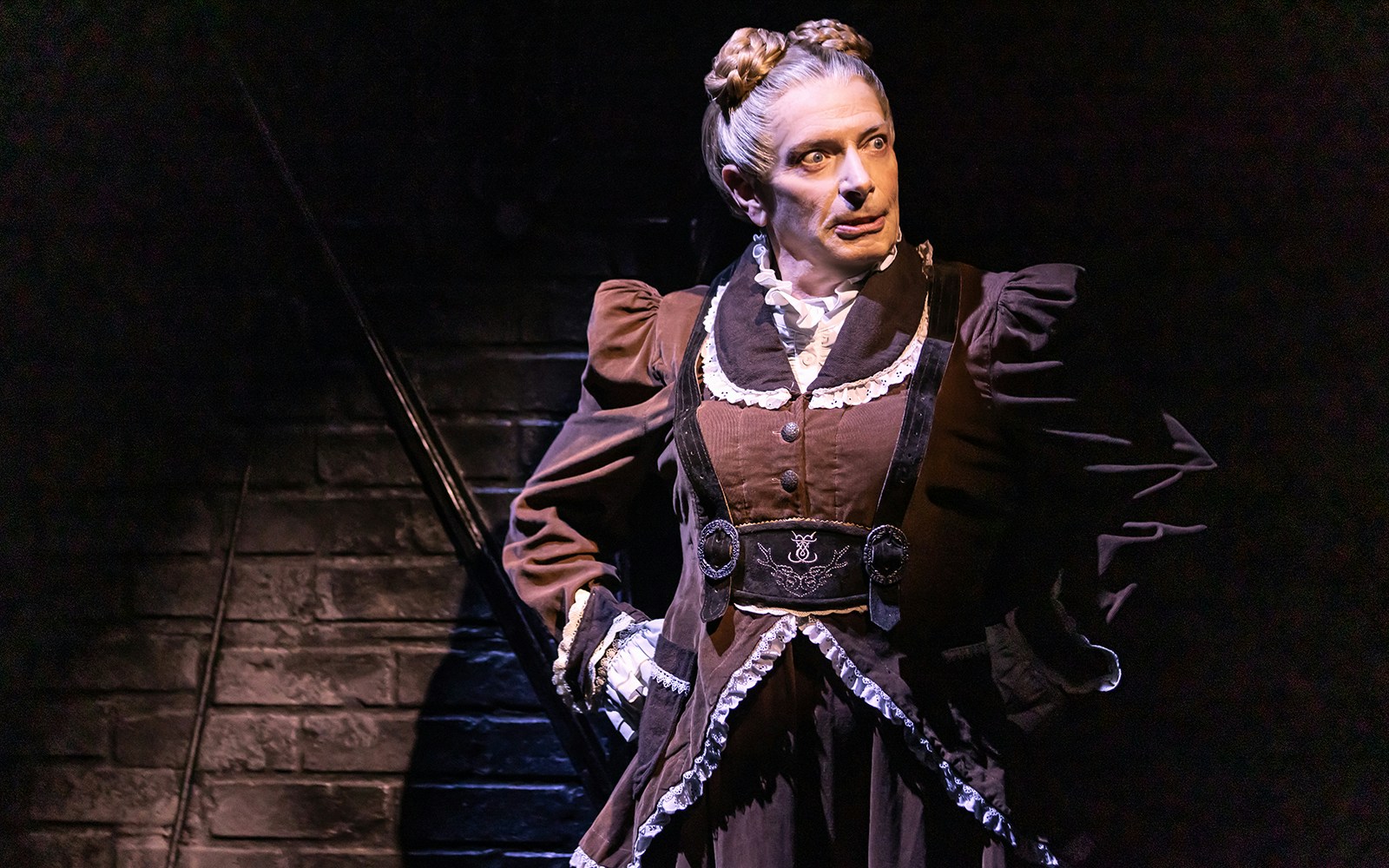 Performer in period costume on stage in "Dracula, A Comedy of Terrors" play.