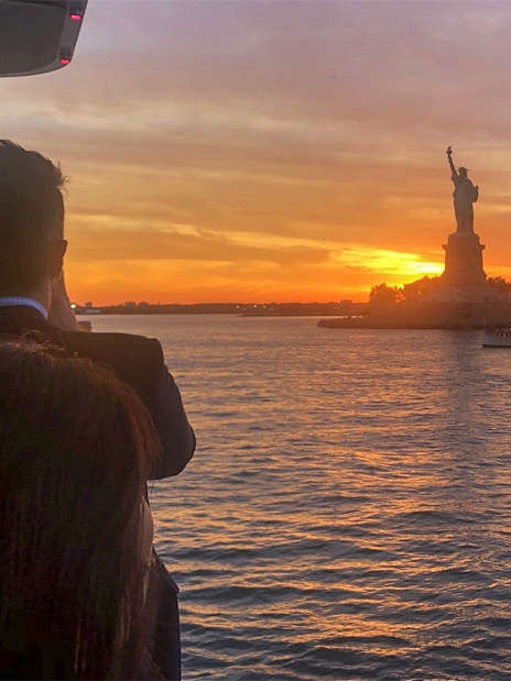 Sunset view of the Statue of Liberty from an Ellis Island cruise.