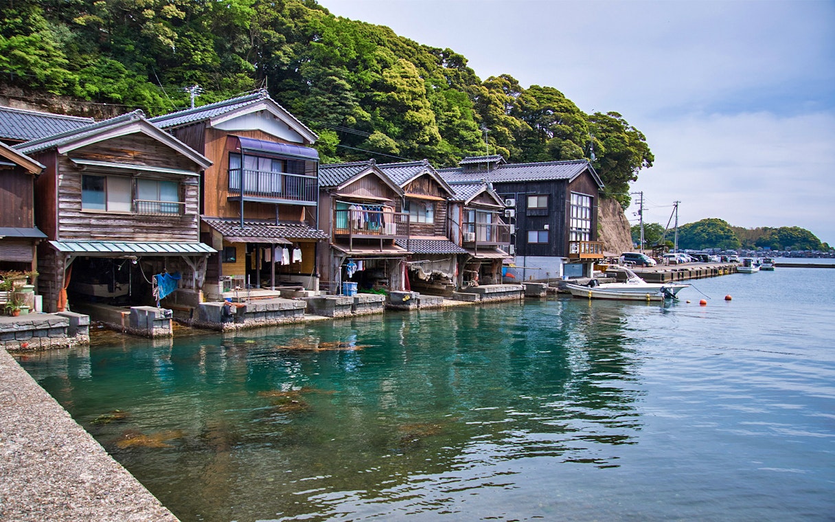 Traditional boathouses along the water in Ine, Kyoto Day Tour.