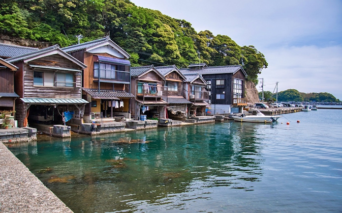 Traditional boathouses along the water in Ine, Kyoto Day Tour.