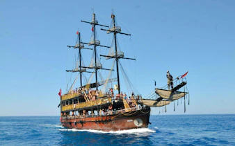 Pirate-themed boat with tourists sailing in Alanya, Turkey.