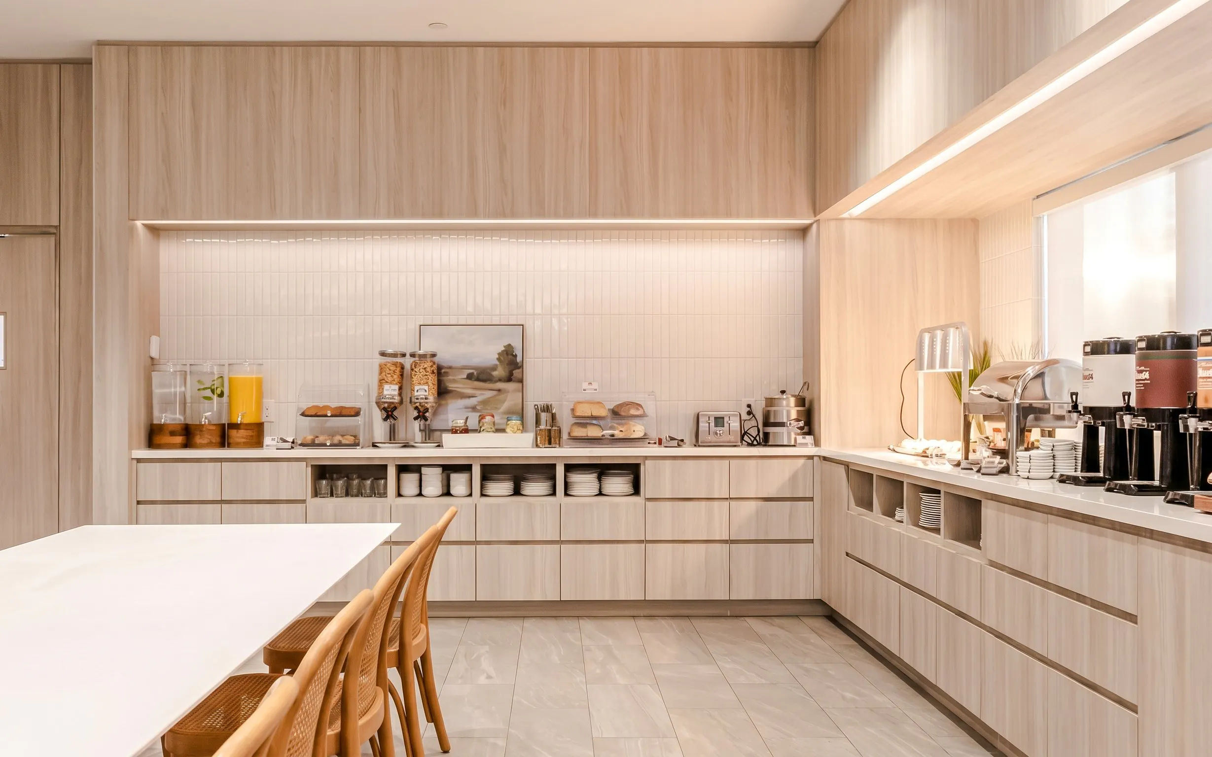 Buffet area at Plaza Premium Lounge, Terminal 1, Toronto Pearson Airport, featuring beverages and snacks.