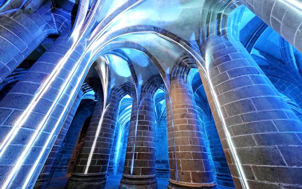 Mont-Saint-Michel Abbey illuminated arches during immersive night tour.