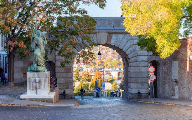 Vienna Gate on Buda Hill with statue and autumn trees, Budapest, Hungary.