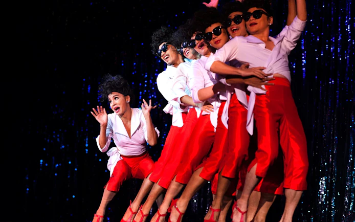 Performers in red outfits at Calypso Cabaret show, Bangkok.