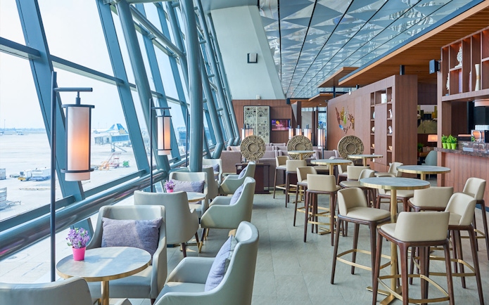 Sapphire Lounge seating area, T3 International Departures, near Gate 7, with airport view.