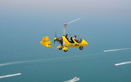Gyrocopter flying over the sea at Skydive Dubai Palm Drop Zone.